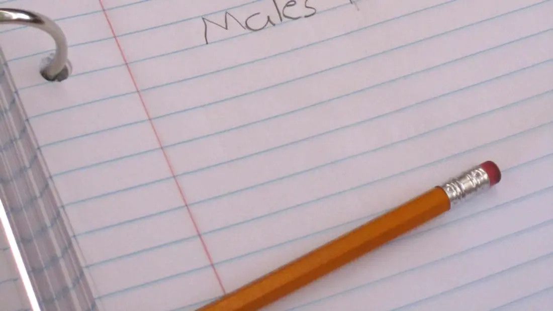 A tutor writing progress notes after a lesson