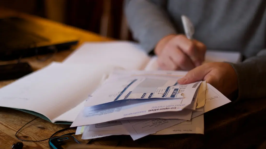 Desk with paperwork and a calculator for tracking tutor payouts